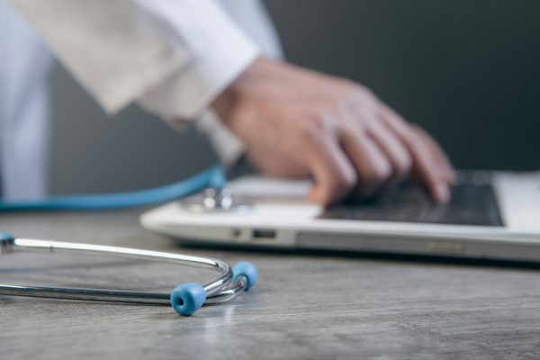 Stock image of a doctor using a laptop