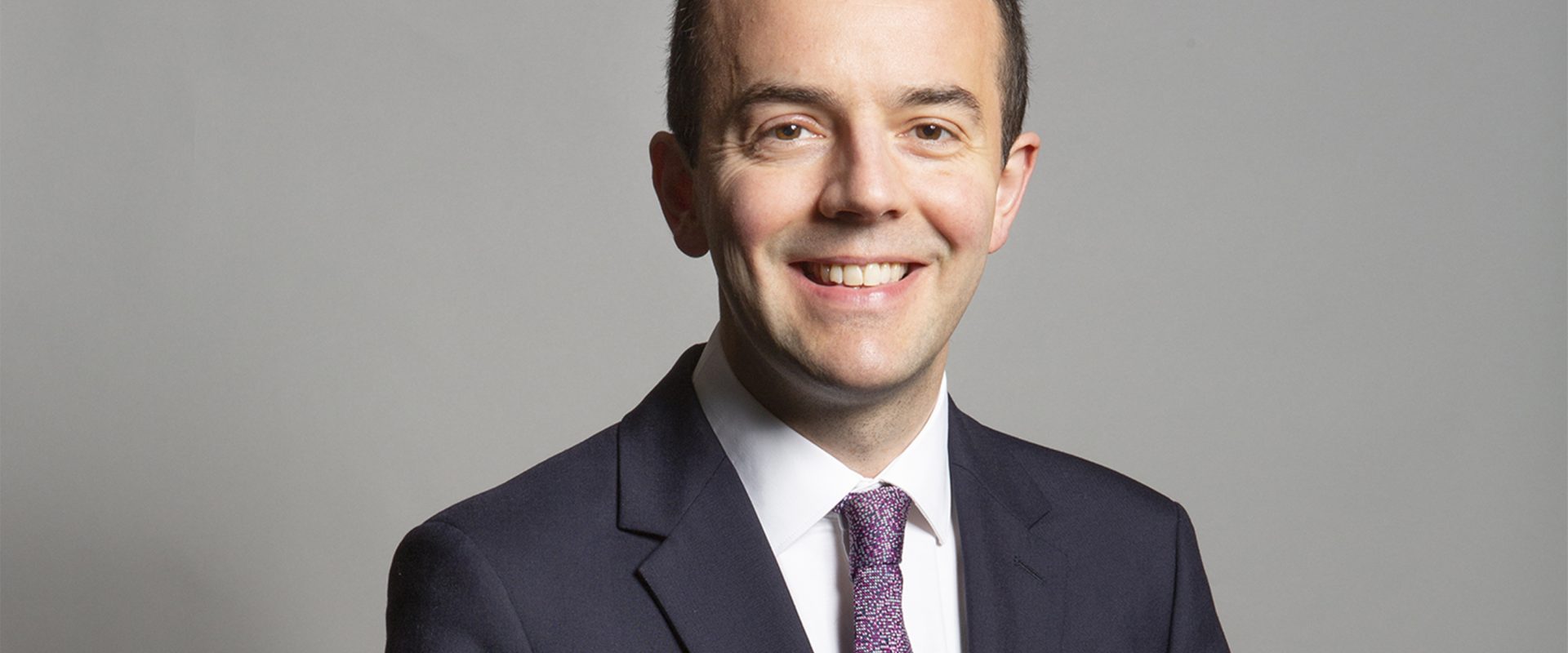 Official portrait photo of health secretary James Murray